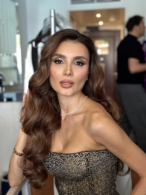 Evening glam makeup with voluminous long waves and embellished strapless dress, backstage