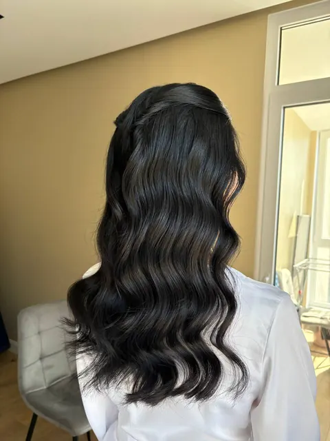 Long glossy dark waves with twisted half-up detail, back view