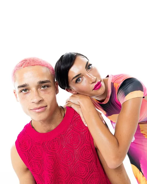 Male model with pink hair and female model with graphic makeup, studio shoot