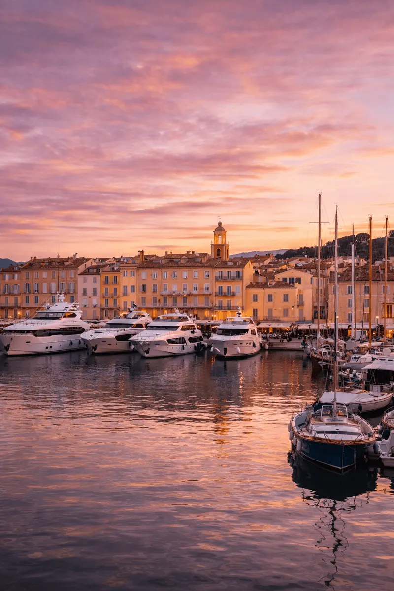 Saint-Tropez harbour at sunset with yachts and the old town